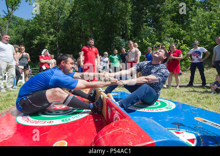 KAZAN, RUSSIA - JUNE 23, 2018: Traditional Tatar festival Sabantuy - Men fighting in national wrestling at summer day outdoors Stock Photo