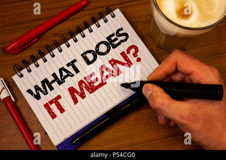 Word writing text What Does It Mean Question. Business concept for Confusion Curiosity Questioning Inquire Hand grasp black marker wooden desk red pen Stock Photo