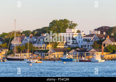 Boats moored and docked in the harbor, overlooked by stately sea captains' homes in Edgartown, Massachusetts on Martha's Vineyard. Stock Photo