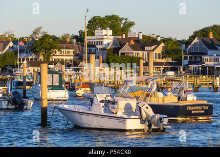 Boats moored and docked in the harbor, overlooked by stately sea captains' homes in Edgartown, Massachusetts on Martha's Vineyard. Stock Photo