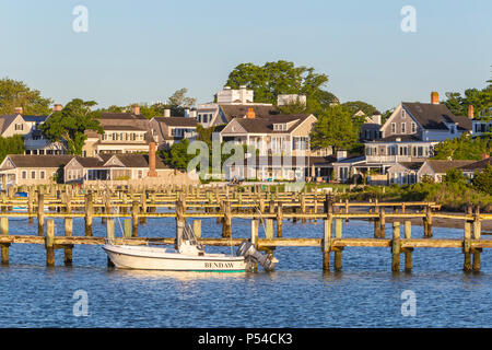 A boat docked in the harbor, overlooked by stately sea captains' homes in Edgartown, Massachusetts on Martha's Vineyard. Stock Photo
