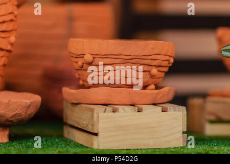 Beautiful handmade ceramic pot and vase in exotic patterns at night market. Stock Photo