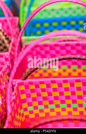 Beautiful pink plastic baskets for sale in local market, Bangkok, Thailand Stock Photo