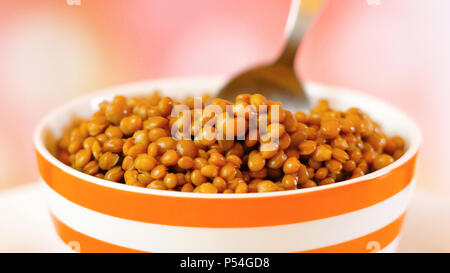 Lentil beans, healthy source of dietary fibre and protein, macro closeup with spoon. Stock Photo