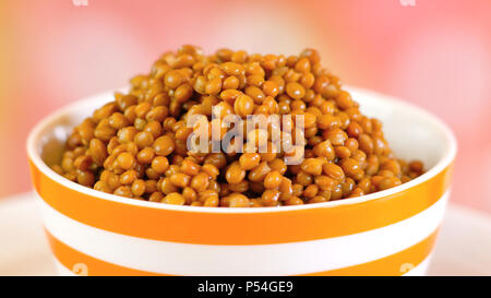 Lentil beans, healthy source of dietary fibre and protein, in bowl closeup. Stock Photo