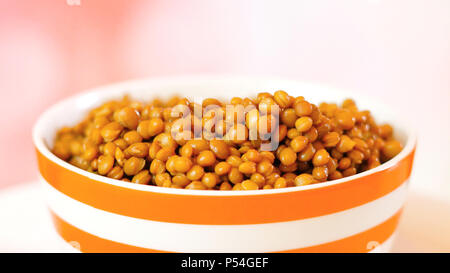 Lentil beans, healthy source of dietary fibre and protein, in bowl closeup with copy space. Stock Photo