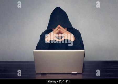 professional programmer thinking how to design developing online steal system through code language and hacking identity information, thoughtful hacke Stock Photo