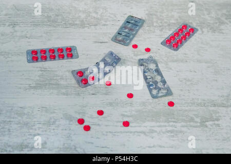 Top view of the pills on the white background, The drug and capsule pills on the floor, Pile of the drug and pills on the white background. red pill Stock Photo