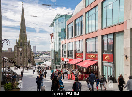 Shoppers in the Bullring shopping centre looking towards St martin church, Birmingham, England, UK Stock Photo