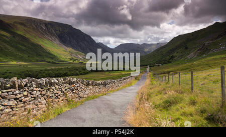 Road through Nant Ffrancon valley, Snowdonia, North Wales under stormy skies Stock Photo