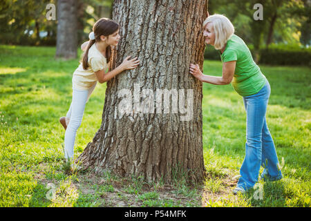 Grandmother and granddaughter are having fun together in park. Stock Photo