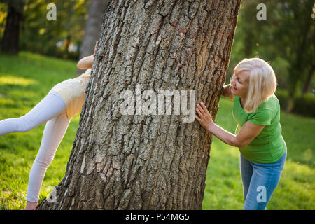 Grandmother and granddaughter are having fun together in park. Stock Photo