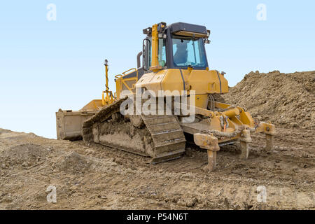 yellow bulldozer at a loamy construction site Stock Photo