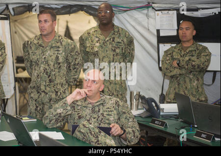 Capt. Bradley Andros, the Commodore of Command Task Force 56, is briefed on matters pertaining to Exercise Eager Lion 2017. Eager Lion is an annual U.S. Central Command exercise in Jordan designed to strengthen military-to- military relationships between the U.S., Jordan and other international partners. This year's iteration is comprised of about 7,200 military personnel from more than 20 nations that will respond to scenarios involving border security, command and control, cyber defense and battlespace management. Stock Photo