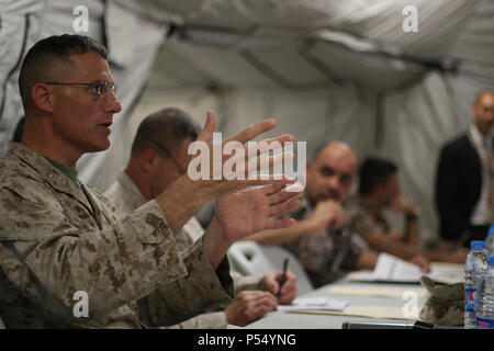 U.S. Marine Corps Col. Leonard Defrancisci, deputy commander of the Force Headquarters Group, Marine Forces Reserve, responds to simulation reports briefed, May 10, 2017, by members of the Joint Operations Center at the Joint Training Center in Jordan. Defrancisci is participating in Exercise Eager Lion 2017 as the Combined Joint Task Force joint chief of staff. Eager Lion is an annual U.S. Central Command exercise in Jordan designed to strengthen military-to-military relationships between the U.S., Jordan and other international partners. This year's iteration is comprised of about 7,200 mili Stock Photo