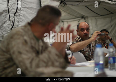 Jordan Armed Forces Gen. Yosef Al Khateeb, director of the Jordan Armed Forces Joint Operations Center, responds to simulation reports briefed, May 10, 2017, by members of the Joint Operations Center at the Joint Training Center in Jordan. Al Khateeb is participating in Exercise Eager Lion 2017 as a joint chief of staff. Eager Lion is an annual U.S. Central Command exercise in Jordan designed to strengthen military-to-military relationships between the U.S., Jordan and other international partners. This year's iteration is comprised of about 7,200 military personnel from more than 20 nations t Stock Photo