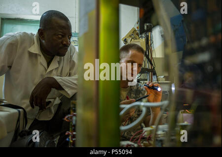 Chadian Lt. Djenaissem Bekoutou, a biomedical technician, and U.S. Army Reserve Chief Warrant Officer 2 Doug Sires, a health services maintenance technician, assigned to 3rd Medical Command Deployment Support in Forest Park, Ga., run diagnostics on a c-arm machine during Medical Readiness Training Exercise 17-3 at the Military Teaching Hospital in N'Djamena, Chad, May 10. The mutually beneficial exercise offers opportunities for the partnered militaries to share best practices and improve medical treatment processes. Stock Photo