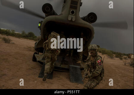 U.S. Air Force and coalition forces board a CH-47 Chinook helicopter at Florence, Ariz., during Angel Thunder 17, May 9, 2017. Angel Thunder is a two-week, Air Combat Command-sponsored, joint certified and accredited personnel recovery exercise focused on search and rescue. The exercise is designed to provide training for personnel recovery assets using a variety of scenarios to simulate deployment conditions and contingencies. Stock Photo