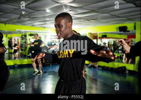 U.S. Army Reserve Soldiers from the 200th Military Police Command participate in a Zumba fitness class during a Performance Triad program organized by the command and hosted on Fort Meade, Maryland, May 9, 2017. The three-week fitness program took place from May 5-25 to help Soldiers who had either failed the Army Physical Fitness Test or had been on the Army Body Fat Composition program. The camp focused on the triad of overall health: physical fitness, nutrition and sleep, by providing education and personalized coaching to Soldiers in all three of those phases of life and more. Stock Photo
