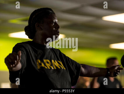 Sgt. 1st Class Karen Goodwin, a U.S. Army Reserve Soldier from the 200th Military Police Command, participates in a Zumba fitness class during a Performance Triad program organized by the command and hosted on Fort Meade, Maryland, May 9, 2017. The three-week fitness program took place from May 5-25 to help Soldiers who had either failed the Army Physical Fitness Test or had been on the Army Body Fat Composition program. The camp focused on the triad of overall health: physical fitness, nutrition and sleep, by providing education and personalized coaching to Soldiers in all three of those phas Stock Photo