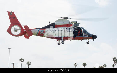 Members of Coast Guard Aids to Navigation Team Los Angeles-Long Beach and an aircrew from Forward Operating Base Point Mugu conducted direct deployment training at Coast Guard Base Los Angeles-Long Beach on May 10, 2017. FOB Mugu and ANT LA-LB often conduct this joint-hoisting training to enhance their skills in conducting operations in remote locations. Stock Photo