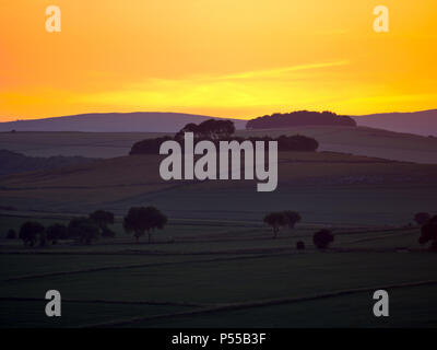 Harborough Rocks, Peak District, UK. 24th June, 2018. Weather UK: Sunset over Minning Low hill Historic England monument with a chambered tomb & two bowl barrows viewed from Harborough Rocks, Peak District National Park, Derbyshire, UK Credit: Doug Blane/Alamy Live News