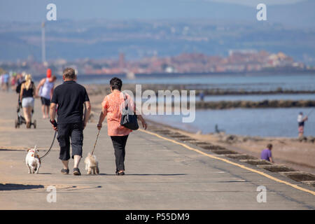 Prestatyn, North Wales 25th June 2018. UK Weather – As high pressure takes hold of many parts of the UK for the coming days with temperatures expected to reach 30C many people make use of the hot weather. People enjoying the hot weather at coast and seaside resort of Prestatyn, North Wales Stock Photo