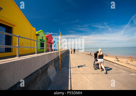 People enjoying a walk along Prestatyn Promenade and beach goers during a heat wave, North Wales, UK Stock Photo