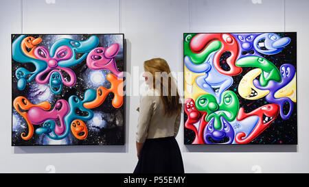 London, UK.  25 June 2018.  A staff member views a painting at the preview of 'blobz', a new solo exhibition by cult American artist Kenny Scharf, known as the grandfather of Street Art.  This is the artist's first UK exhibition in ten years and is being held at the Opera Gallery in New Bond Street 26 June to 10 July 2018.  Credit: Stephen Chung / Alamy Live News Stock Photo