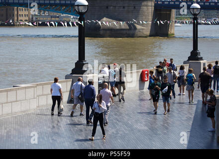 London, UK. 25th Jun, 2018. People enjoy the sunshine by the River Thames in London, the weather forecast is to remain hot and sunny for the rest of the week.Credit Keith Larby/Alamy Live News Stock Photo