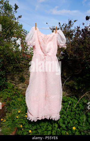 Light pink vintage dress hanging on a washing line Stock Photo