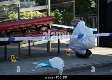 Police forensic officers gather evidence at a bus stop on Redcliff Hill near to where man has died and two men have been taken to hospital with life-threatening injuries following an aggravated burglary in Prewett Street, Bristol.