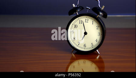 Classic style alarm clock on table with reflection Stock Photo
