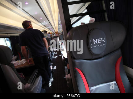 Passengers boarding a London North Eastern Railway (LNER) train during the launch event for the new service, which replaces the failed rail franchise Virgin Trains East Coast (VTEC), at Kings Cross station in London. Stock Photo
