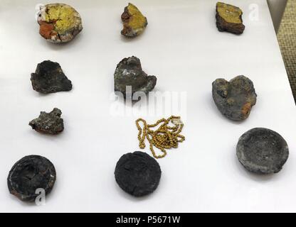 Remains of vitreous mass, clay's crucible and pearls. 13th century. Museum of History and Navigation. Riga. Latvia. Stock Photo