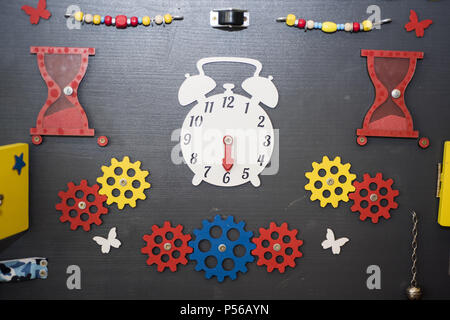 Wooden big yellow clock in playground. Time abstraction. Stock Photo