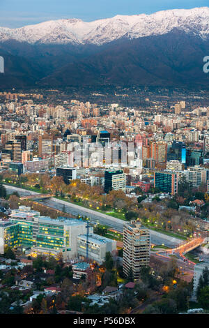 Santiago, Metropolitan Region, Chile - June 01, 2013: Panoramic view of Providencia district with Mapocho River and the snowed Andes mountain range in Stock Photo