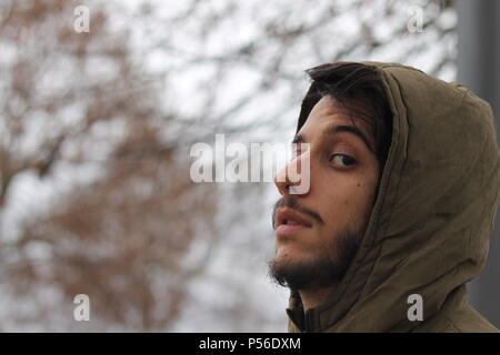 Young men thinking with his hand on chin. Looking upset or sad. Stock Photo