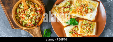 Traditional Mexican dish - chimichanga. Corn cake with minced meat, pepper, onion, garlic, oregano, zira and guacomole sauce from avocado Stock Photo