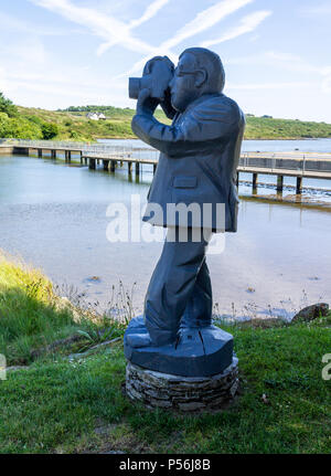 wood carving of a camera man painted grey in ballydehob Ireland Stock Photo