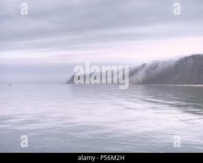 Dark sky above  a blue ocean.  heavy cloudy sky in a bad weather. Long exposure photography Stock Photo