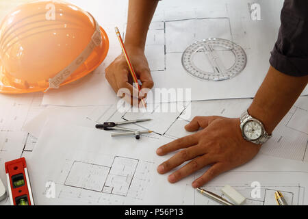 Architect or engineer using pencil and protractor working on blueprint, architectural concept Stock Photo