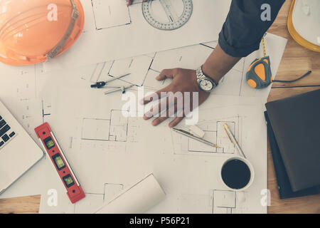 Architect or engineer using pencil and protractor working on blueprint, architectural concept Stock Photo