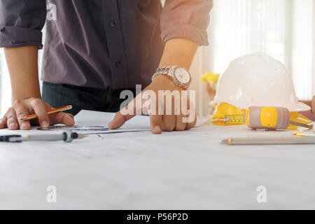 Architect or engineer using pencil and protractor working on blueprint, architectural concept Stock Photo