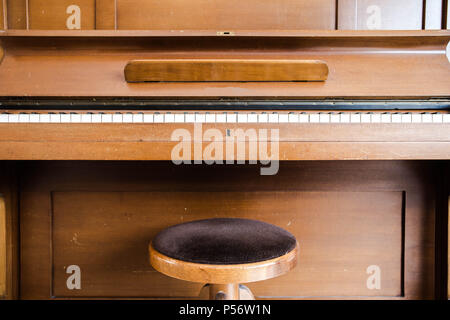 Old wooden vintage piano keys on wooden musical instrument in front view Stock Photo