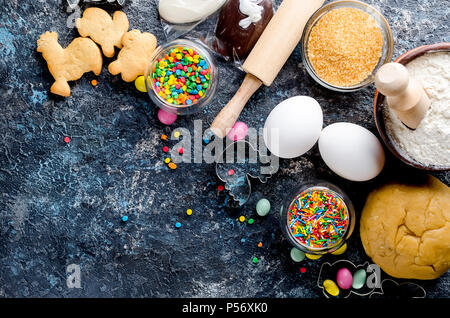 Happy Easter card. Easter biscuits,  cuttings, candy eggs and ingredients for baking rolled dough dough Stock Photo