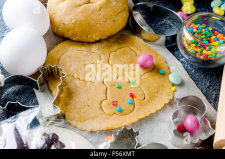 Happy Easter card. Easter biscuits,  cuttings, candy eggs and ingredients for baking rolled dough dough Stock Photo