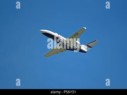 San Marino registered Cessna 525 Citation Jet/m2  T7-FOZ departs Inverness Dalcross airport into clear blue sky. Stock Photo