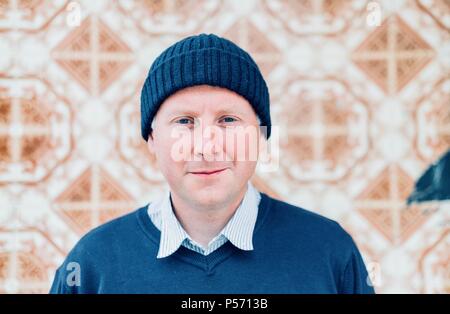 A handsome man wearing navy blue urban clothes and hipster style cap Stock Photo
