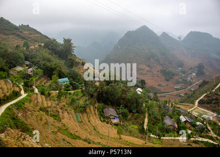 Ha Giang, Vietnam - March 18, 2018: Village surrounded by mountains and fog in the northernmost province of Vietnam Stock Photo